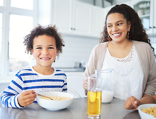 Image showing Sit with us, theres plenty. a mother and son having breakfast at the kitchen table at home.