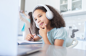 Image showing I have an idea. a little girl looking thoughtful well doing her homework at the kitchen table.