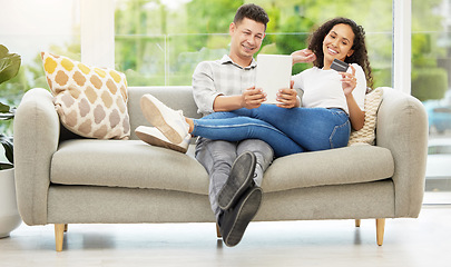 Image showing Never leaving this couch. a couple using a digital tablet and credit card on the sofa at home.