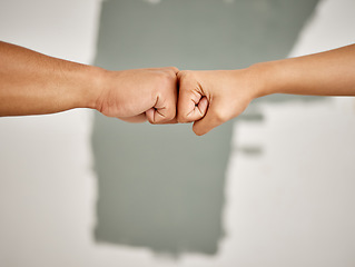 Image showing We can make this house a home. an unrecognizable couple sharing a fist bump while painting at home.