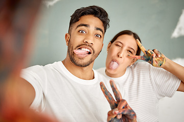 Image showing Doing the renovations yourself is fun. a young couple taking a selfie while painting together at home.