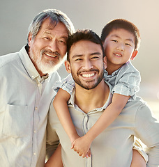 Image showing The men in our family. Cropped portrait of a handsome young man on the beach with his father and son.