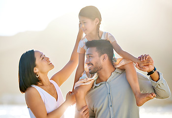 Image showing She is their whole world. a happy diverse family of three at the beach.