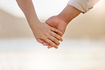 Image showing We all need someone to take long walks on the beach with. Closeup shot of an unrecognizable couple holding hands on the beach.