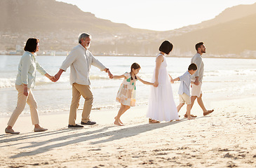 Image showing Family walks on the beach. Full length shot of a happy diverse multi-generational family at the beach.