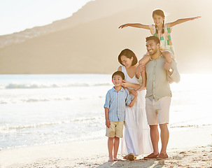 Image showing Theres fun to be had on the beach. Full length shot of a happy diverse family of four at the beach.