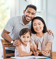 Image showing We are family. young parent helping their daughter with homework at home.