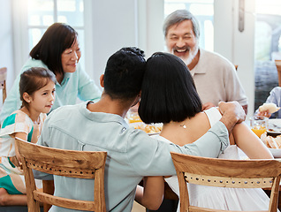 Image showing The family is the first essential cell of human society. a family having lunch at home.