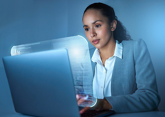 Image showing Im the code master. an attractive young businesswoman sitting alone in the office and using her laptop.