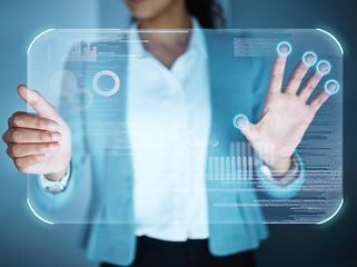 Image showing Running an innovative business. an unrecognisable businesswoman standing alone in the office and using a cgi screen.