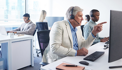 Image showing Happy customers make for a healthy business. Portrait of a mature businessman using a headset and computer in a modern office.