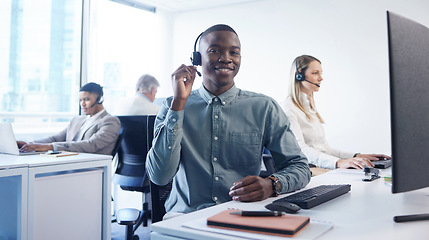 Image showing Customer service is the heartbeat of your brand. Portrait of a young businessman using a headset and computer in a modern office.