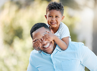 Image showing The bond between a parent and child is unbreakable. a little boy covering his fathers eyes while playing outside.