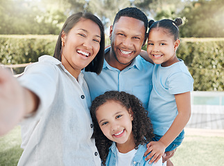 Image showing The love of family is like no other. a couple standing outside with their two daughters.