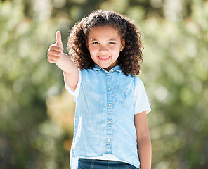 Image showing Spending time outdoors is always fun. an adorable little girl showing thumbs up while standing outside.