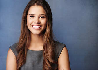 Image showing Confidence makes all the difference in business. Studio portrait of a confident young businesswoman posing against a grey background.