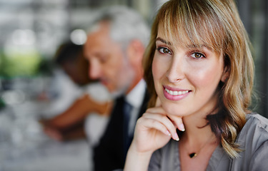 Image showing Dreams seldom materialize on their own. Portrait of a businesswoman sitting in a boardroom meeting with colleagues blurred in the background.