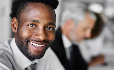 Image showing The future starts today. Portrait of a businessman sitting in a boardroom meeting with colleagues blurred in the background.