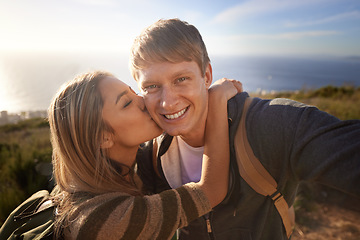 Image showing He comes up with the best ideas. Portrait of a handsome young man getting a kiss from his girlfriend while out on a hike.