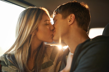 Image showing Romance on the road. an affectionate young couple kissing in a car.