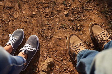 Image showing Get some dirt on your shoes. Cropped high angle shot of two people standing on a dirt track.