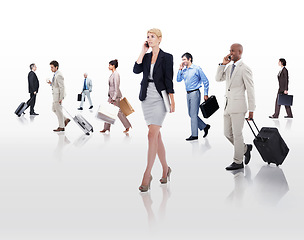 Image showing Always on the go. businesspeople on the move with suitcases and cellphones.