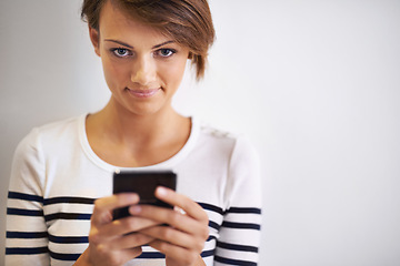 Image showing Ready... steady... text. A cropped portrait of a beautiful young woman using a smartphone.