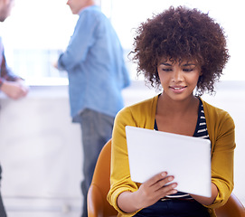 Image showing Checking up on a theory. an attractive young woman looking at a digital tablet.