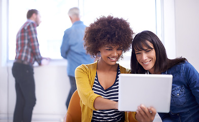 Image showing Theres a whole world of innovation out there. two coworkers looking at a digital tablet.