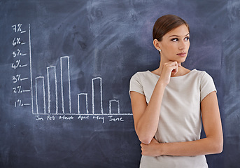 Image showing The business could be doing better. an attractive business woman beside a blackboard.