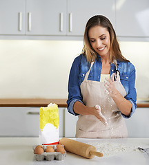 Image showing Doughy goodness. a smiling woman at work in her kitchen making dough.