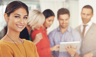 Image showing Ive got a great team behind me. Cropped portrait of a young businesswoman standing in an office with her team in the background.