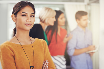 Image showing Ive got confidence in my teams ability to succeed. Cropped portrait of a young businesswoman standing in an office with her team in the background.