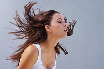 Image showing Freedom. a beautiful young woman flinging her brunette hair.