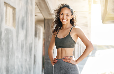 Image showing Working for the body of my dreams. an attractive young woman standing alone in the city during her outdoor workout.