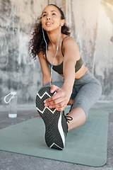 Image showing There will be no sore legs today. a young woman stretching before her outdoor workout in the city.