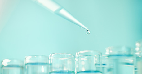 Image showing Running as many tests as possible. a dropper and beakers in a laboratory.