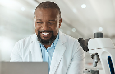 Image showing Thats all the tests done. a handsome mature scientist sitting alone in his laboratory and using his laptop.