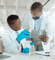 Image showing Looks like we did it. two scientists using a digital tablet in a laboratory.