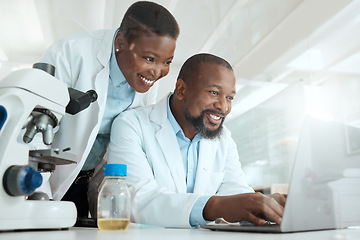 Image showing We can discover a cure together. two scientists using a laptop in a laboratory.