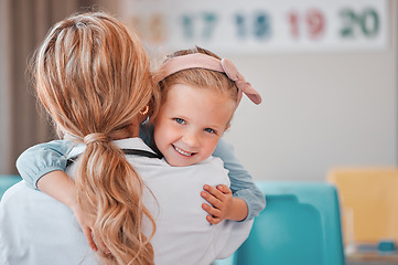 Image showing Child psychology at work. Adorable little girl hugging her female therapist. Mental health and wellness are important issues even for kids. Therapy has improved her mood and made her more confident