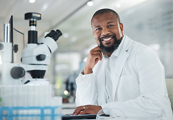 Image showing Sharing viewpoints on the days discoveries. a mature man using a microscope in a lab.