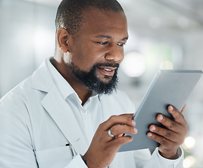 Image showing My work will contribute to an amazing body of research. a male scientist using a digital tablet while working in a lab.