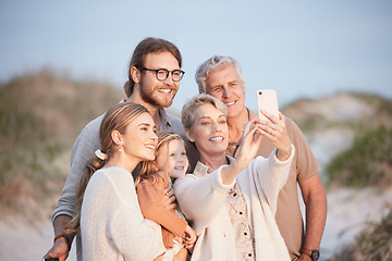 Image showing The best memories are made at the beach. a senior woman taking a selfie at the beach with her family.