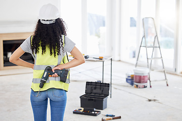 Image showing Where am I placing these nails. an unrecognisable contractor standing alone and holding a power drill in a room during the day.