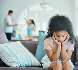 Image showing How to make your daughter resentful. a little girl looking sad on a sofa while her parents argue in the background.