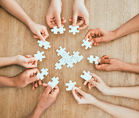 Image showing Completing each other. a family building a puzzle together at home.