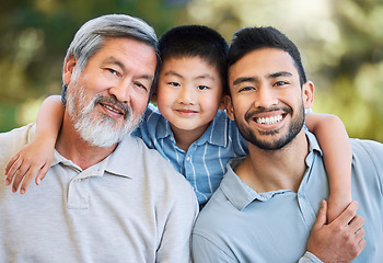 Image showing Family sticks together whatever the weather. an adorable little boy spending a fun day in the park with his father and grandfather.