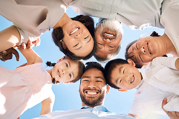 Image showing Surround yourself with people who feel like sunshine. Low angle shot of a happy family huddled together outdoors.