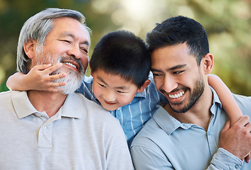 Image showing Three generations of joy. an adorable little boy spending a fun day in the park with his father and grandfather.